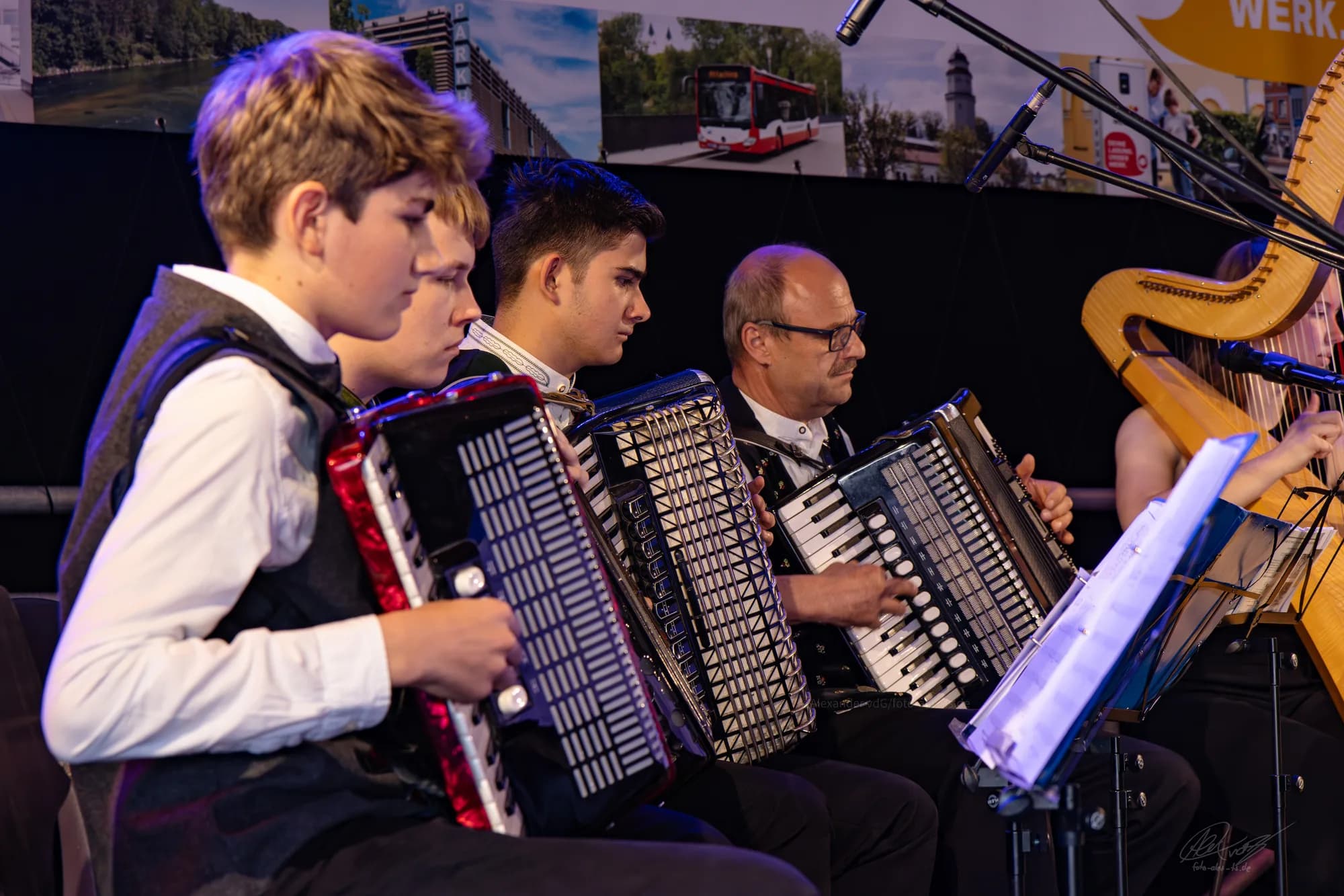 A youth accordion ensemble performing together on stage at the festival.