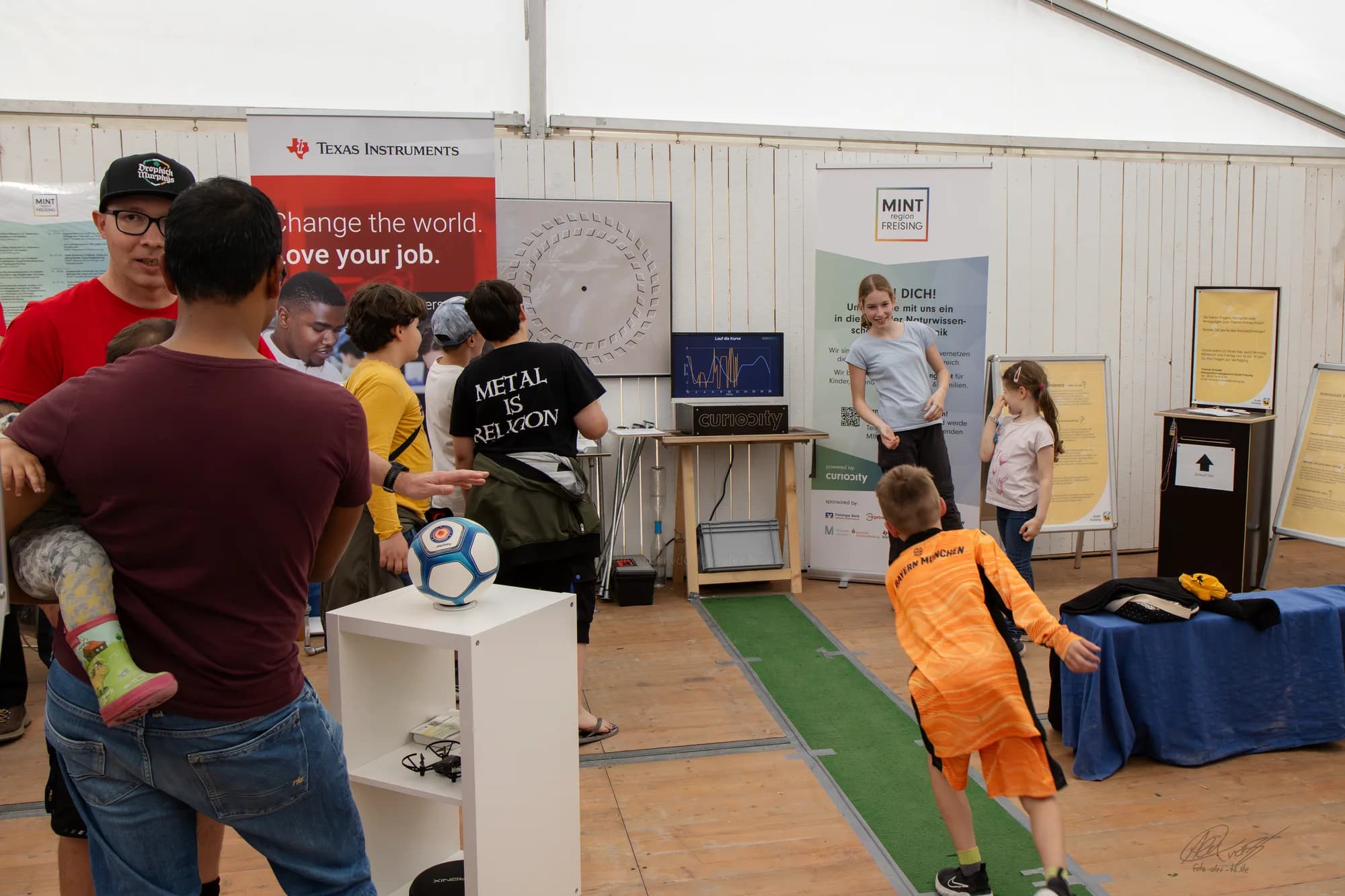 Young visitors engaging with an interactive exhibition station at the festival.