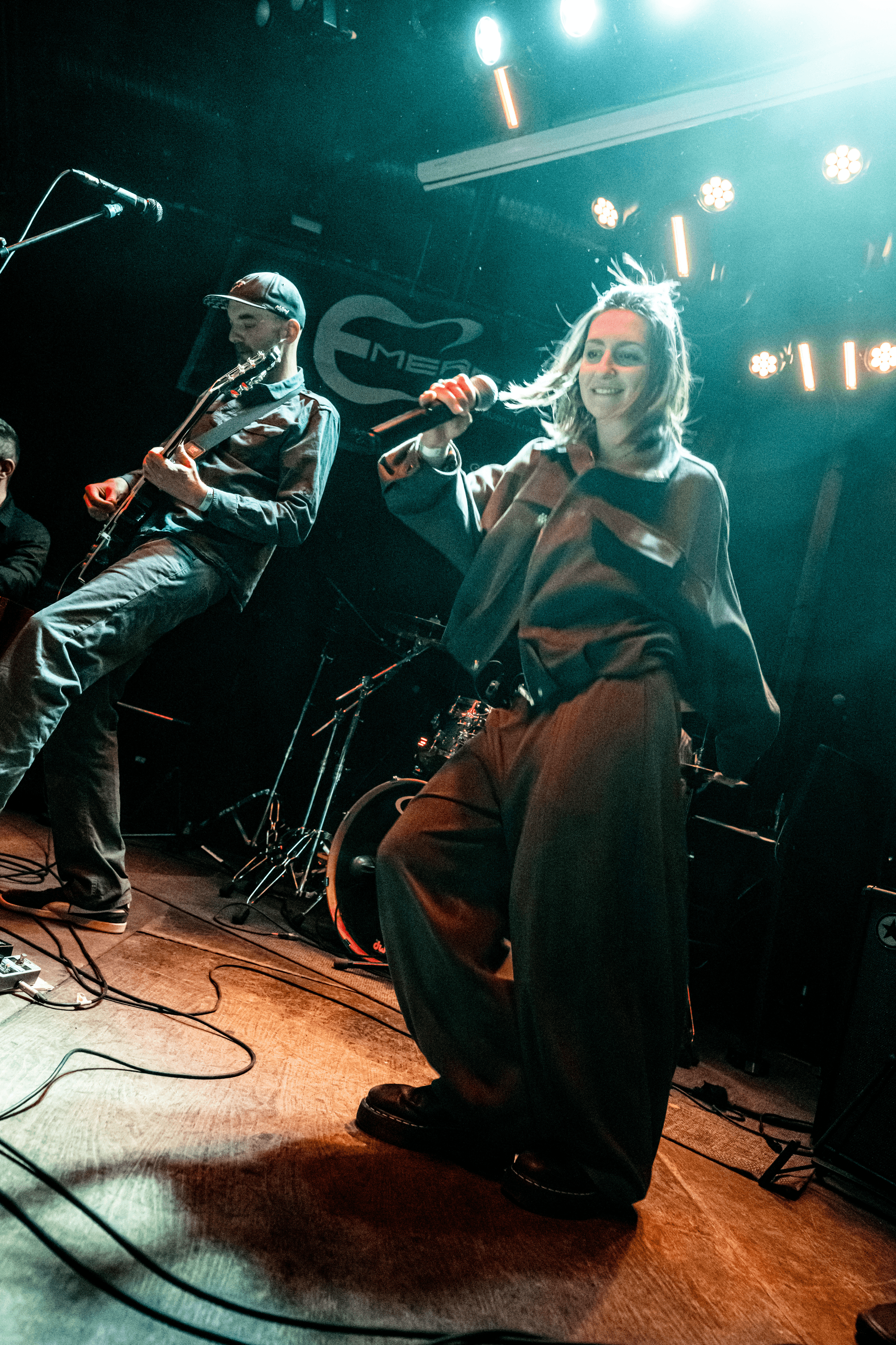 ARMINY band photo with two singers and instruments against a light background